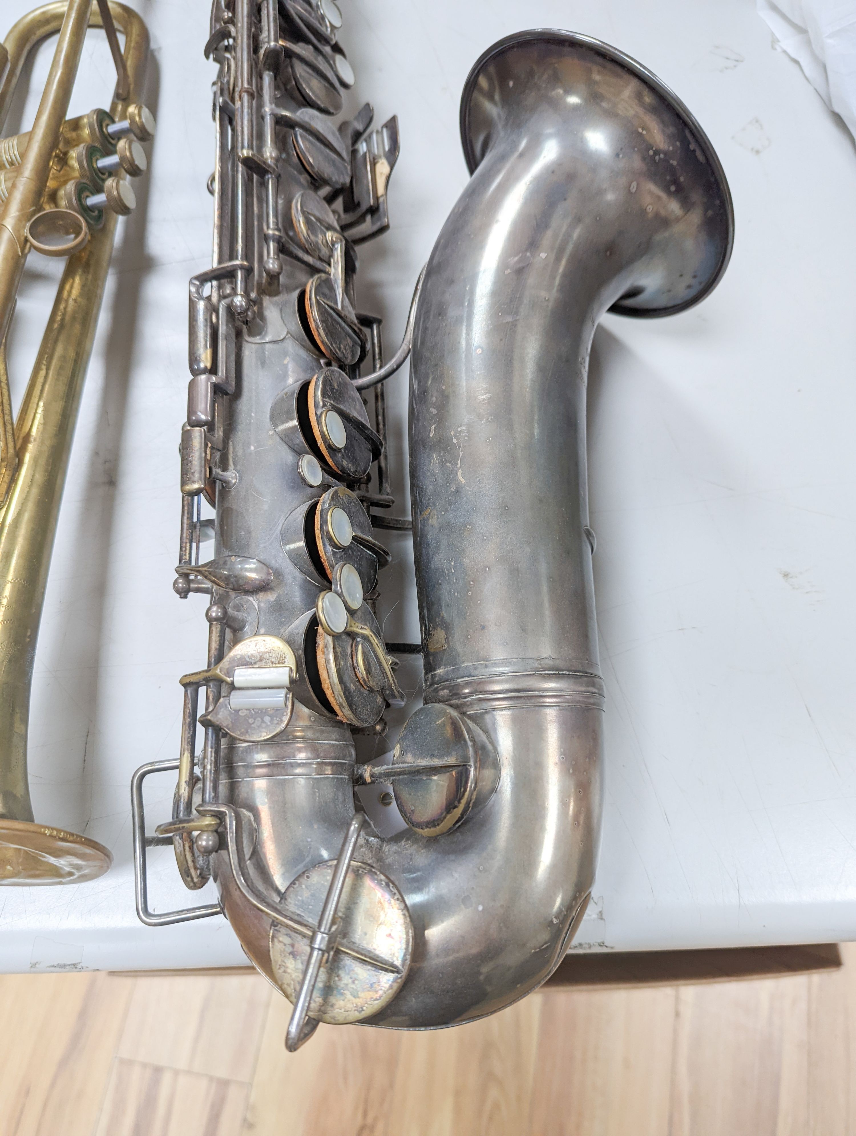 An Excelsior sonorous class A Hawkes & Son saxophone, and a Grafton Dallas, London trumpet with accessories